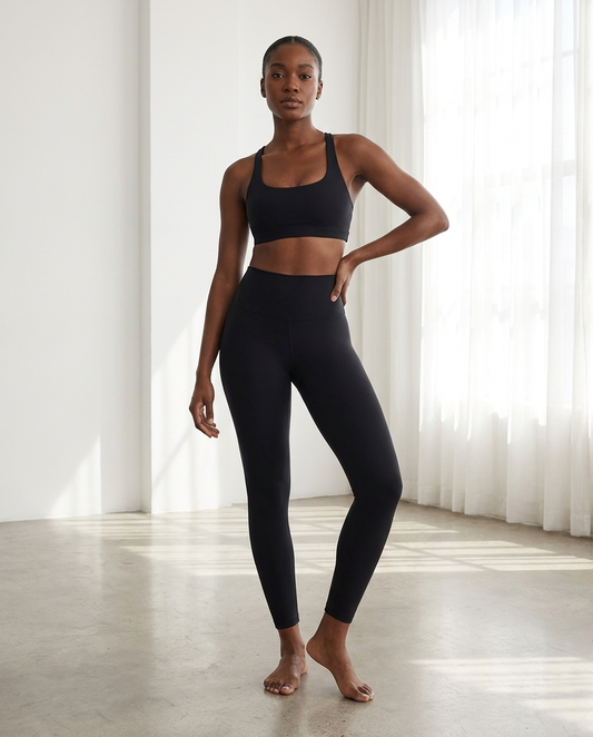 Model wearing Gilded Streets High-Waisted Performance Leggings in studio light