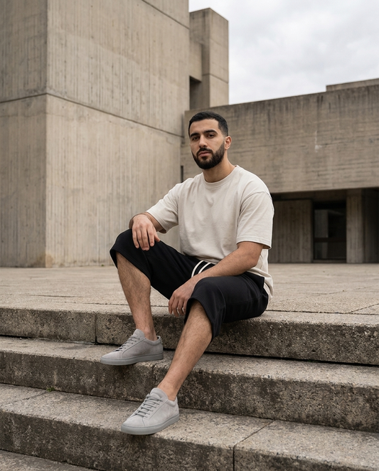 Model wearing Gilded Streets Relaxed Drawstring Three-Quarter Sweatpant on concrete steps