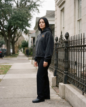 Female model wearing the Vintage Wash Boxy Fleece Hoodie in Black