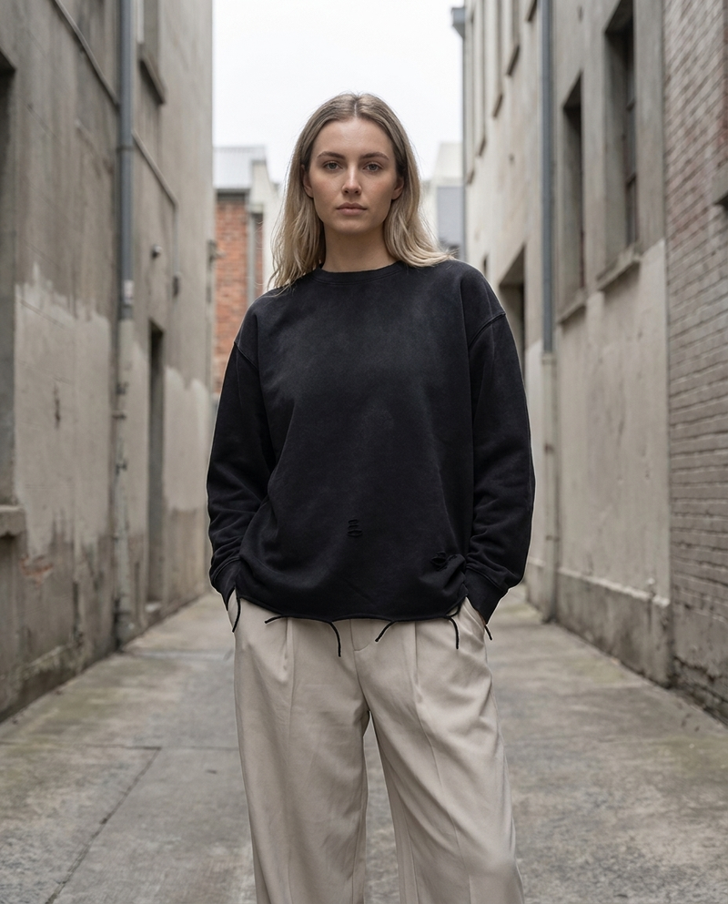 Model wearing Gilded Streets Snow Wash Raw Edge Tee, oversized unisex fit