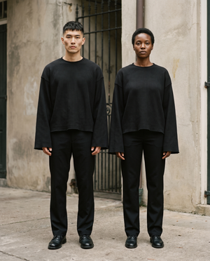 Male and female models wearing the Waffle Knit Raw Hem Long Sleeve Tee in Black